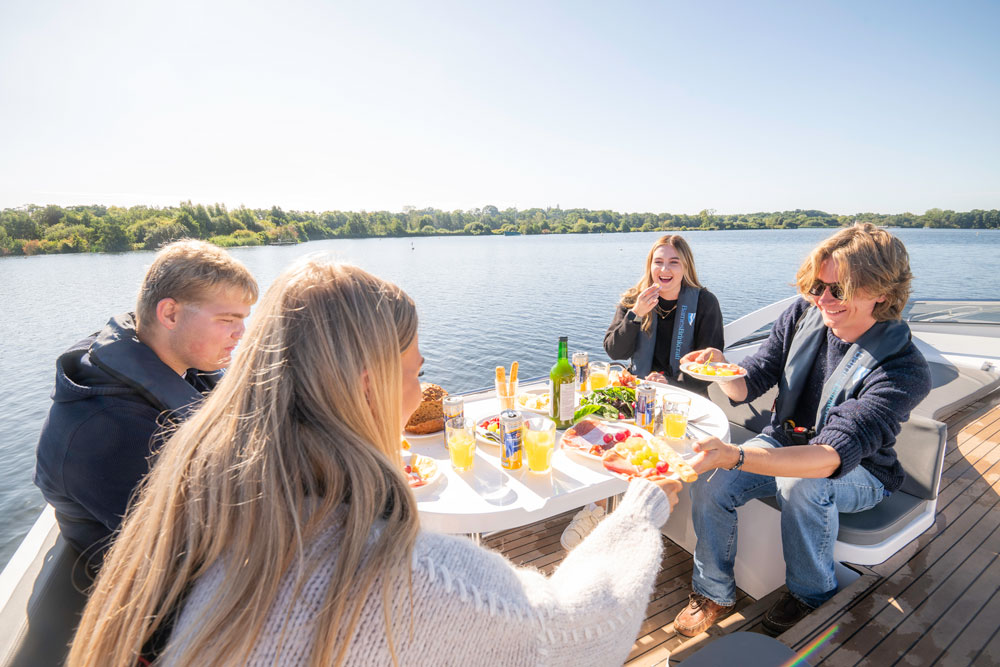 A group of friends enjoying a meal on the deck of Barens prelude